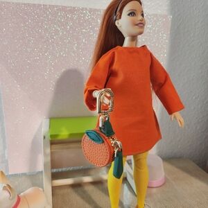 A Orange Dress designed for dolls  such as curvy and made to move dolls.
